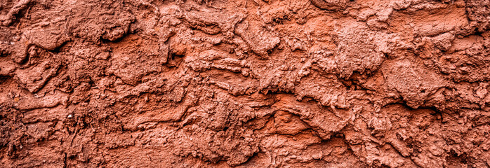 Fototapeta premium Red dry grungy clay tennis background texture. Banner