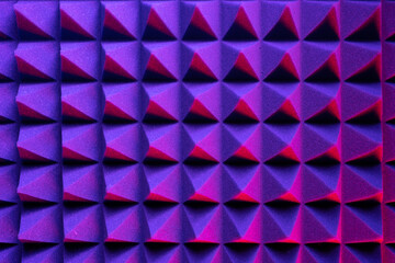 Abstract pyramid background in colored light. Foam material