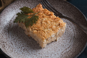 cauliflower casserole on a plate and dark background