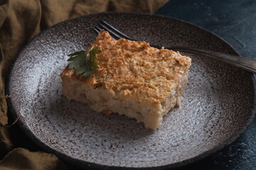 cauliflower casserole on a plate and dark background