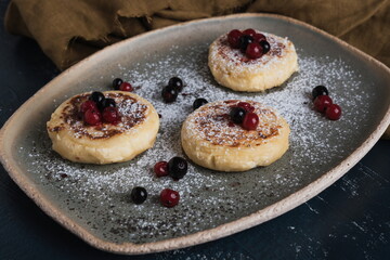cottage cheese pancakes with wild berries and powdered sugar