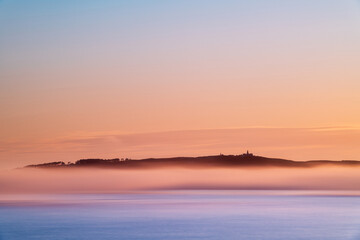 Panorama view of Ons and Onza islands in the Ría de Pontevedra in Galicia under heavy fog, Spain.