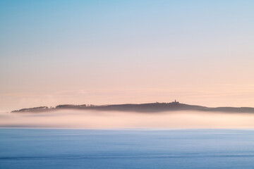 Panorama view of Ons and Onza islands in the Ría de Pontevedra in Galicia under heavy fog, Spain.