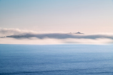 Naklejka na ściany i meble Panorama view of Ons and Onza islands in the Ría de Pontevedra in Galicia under heavy fog, Spain.