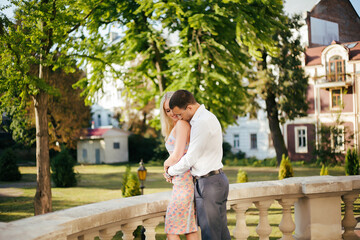 Fototapeta premium Young couple in love hug each other on city background