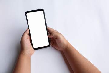 Closeup shot of a woman typing on mobile phone isolated on white background.Blank screen to put it on your own webpage or message.

