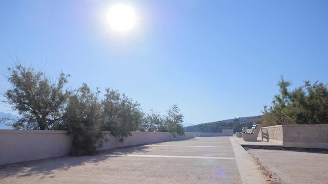 Promenade by the sea on a beautiful summer morning. Adriatic coast in Croatia. Postira, island of Brac.
