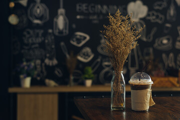Iced coffee on wooden table in coffee shop