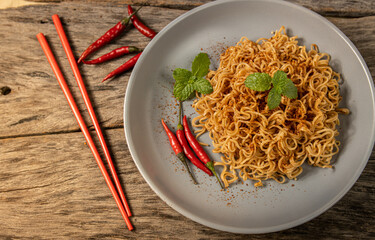 instant noodles in the red bowl on wooden background
