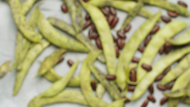 Top view green bean pods and beans. Close up food background, texture, blurry image at the beginning is focused at the end