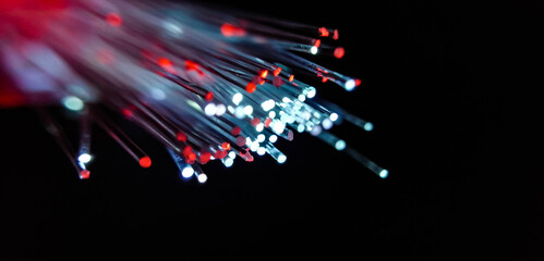 This picture displays colored bottle lights which look like fiber optic cables. The background is black.