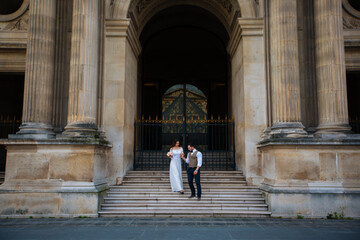 wedding couple. The bride in a beautiful wedding dress, the bride in a stylish tuxedo, Paris France