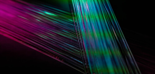 Fototapeta premium This picture displays colored bottle lights which look like fiber optic cables. The background is black.