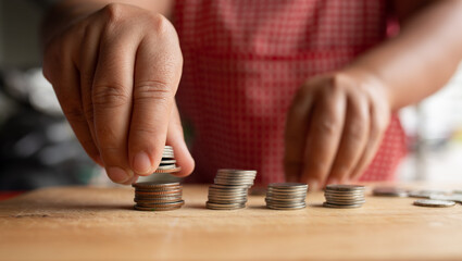 Food vendor woman hands counts the money.In Thailand,saving money or counting money concept.