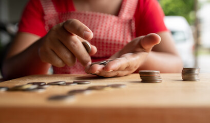 Food vendor woman hands counts the money.In Thailand,saving money or counting money concept.