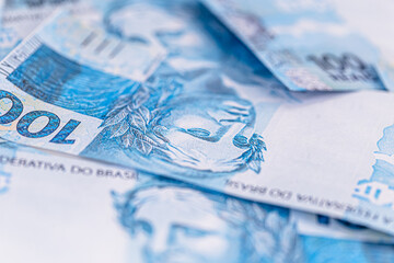 one hundred Brazilian reais banknotes thrown, fallen, concept of brazil's financial crisis and recession or inflation