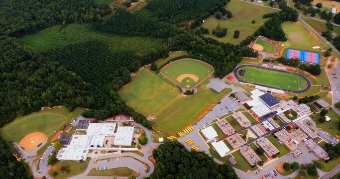Southern Alamance High School and Southern Middle School. We pass over a rural high school in Graham, North Carolina with multiple buildings, baseball field, football field, track, tennis courts.
