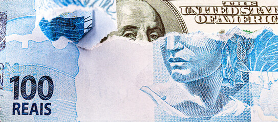 detail of a banknote of 100 reais from brazil beside a hundred dollar bill of american dollars,...