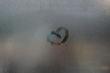 condensation water droplets in mirror for background.Hand Drawn heart on the window