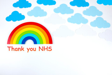 Text Thank You NHS. Rainbow with clouds on white background with text. Rainbow banner.