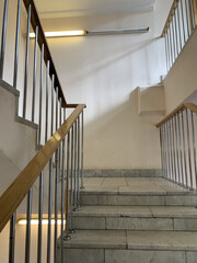 Vertical shot of an old stone staircase in the corridor