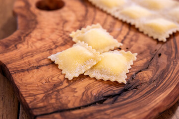 Handmade uncooked fresh ravioli with four cheeses filling, tasty vegetarian food