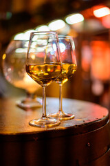 Two glasses of cold dry white wine served outdoor in cafe at night in Italy