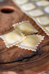 Handmade uncooked fresh ravioli with four cheeses filling, tasty vegetarian food