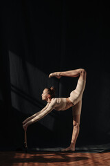 Fototapeta na wymiar Young gymnast girl stretching and training