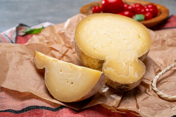 Italian semi hard matured caciocavallo cheese, handmade and aged in natural underground caves in Apulia region
