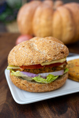 Making fresh and healthy vegetarian hamburgers with grilled pumpkin burgers, organic buns and vegetables