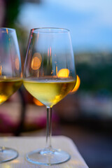 Two glasses of cold dry white wine served outdoor in cafe at night in Italy