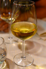 Two glasses of cold dry white wine served outdoor in cafe at night in Italy