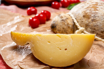 Italian semi hard matured caciocavallo cheese, handmade and aged in natural underground caves in Apulia region