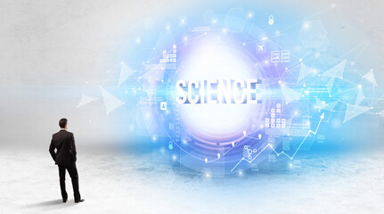 Rear view of a businessman standing in front of SCIENCE inscription, modern technology concept