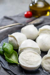 Tasty italian food, fresh white buffalo mozzarella soft cheese balls from Campania, tomatoes, fresh basil and olive oil