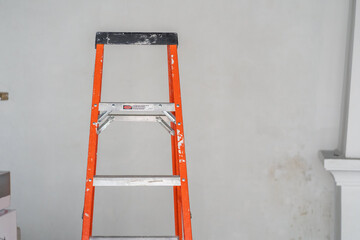 ladder in front of white wall © rod