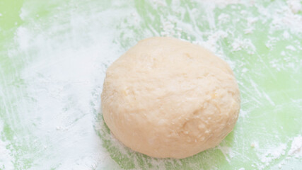The process of raising the dough on the light green plastic board. Dough made from natural sourdough and organic wheat dough. The successful of ferrmentation stag for bakery.