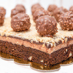 Brownie dessert with ferrero rocher balls and layer of chopped walnuts