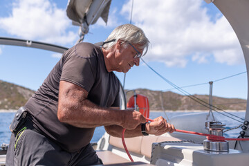 A man sailing a boat in the Mediterranean Sea