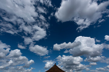 Roof with blue sky and flying clouds