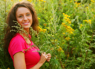 young woman outdoor in the grass in summertime