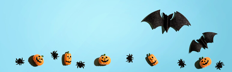 Halloween paper bats and small pumpkin ghosts - flat lay