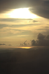 Destination twilight and paradise of golden sunrise and sunset shining to the mist and fog in the jungle on the valley mountain. Aerial view of Rainy season in the tropical rainforest in Thailand.