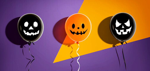 Halloween balloon ghosts with happy faces - flat lay