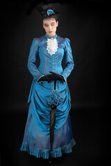 A young Victorian woman wearing an 1880s ensemble