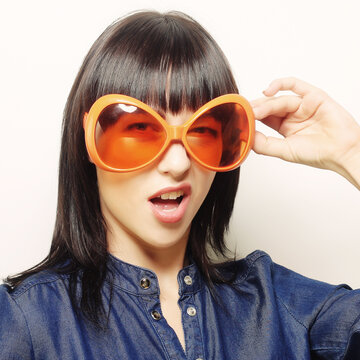 happy woman with big orange sunglasses