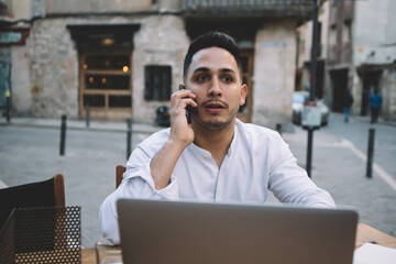 Serious ethnic manager calling client