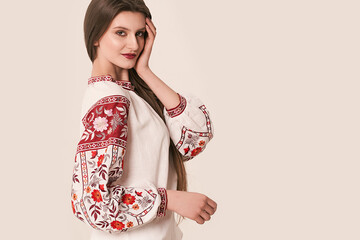 Young beautiful brunette girl wearing gorgeous ethnic style embroidered shirt, modern derivative...