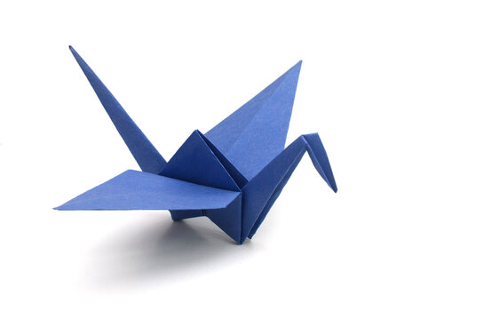 a blue origami bird paper on white